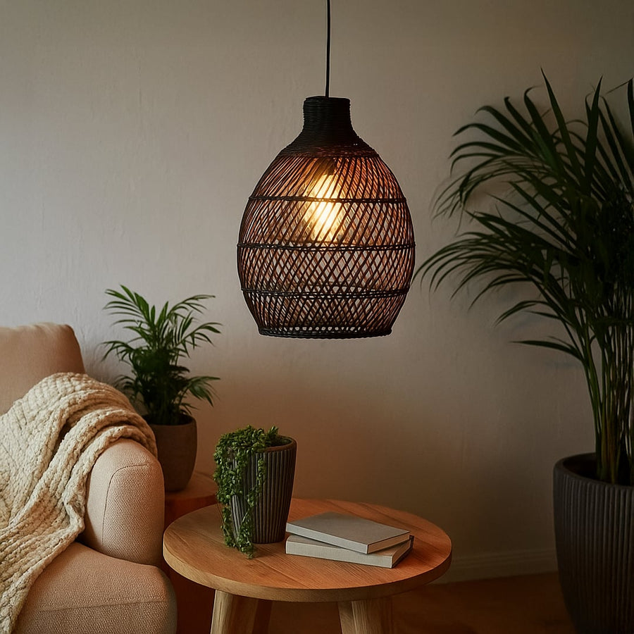 Black woven rattan pendant light adding a warm natural accent to modern interiors with its artistic handwoven organic design.