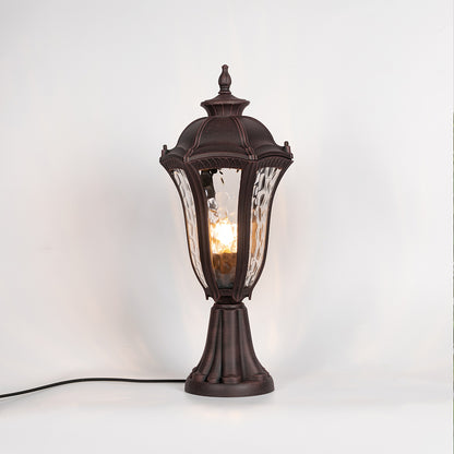 Vintage outdoor gate light with black metal frame and warm glowing glass shade for elegant decor use.