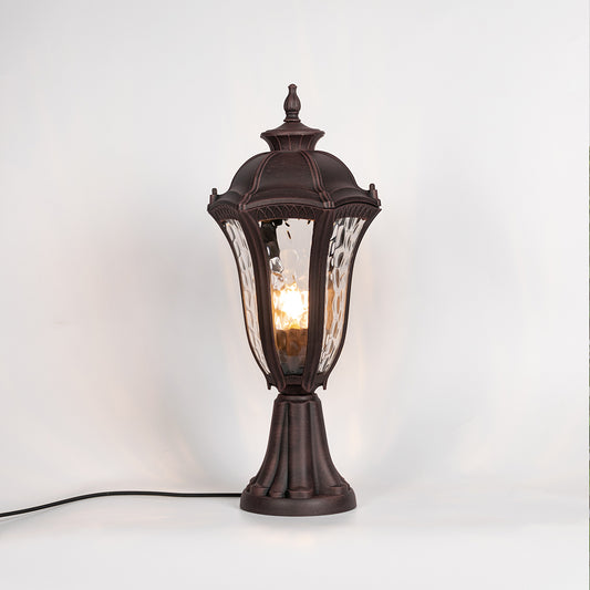 Vintage outdoor gate light with black metal frame and warm glowing glass shade for elegant decor use.