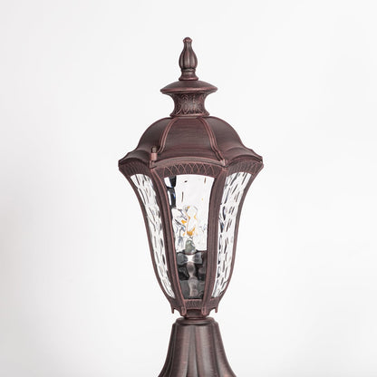 Closeup of antique brown pillar light showing detailed patterned glass and vintage design for classic exterior lighting.