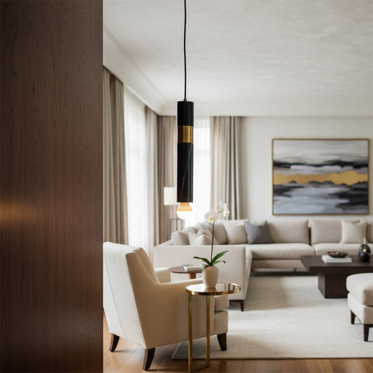 Elegant vertical pendant light illuminating a seating area enhancing contemporary living room decor with soft warm lighting appeal.