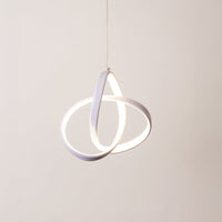 White metal LED pendant light with glowing rings designed for elegant modern interior decor.