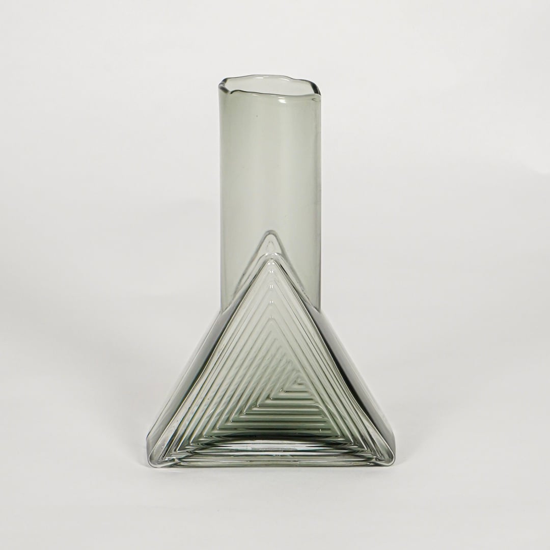 triangle geometric shape glass vase grey white background