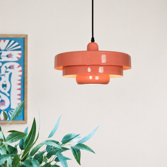 Lifestyle image of pink triple layer disc pendant light for elegant dining room decor styling and modern home lighting.