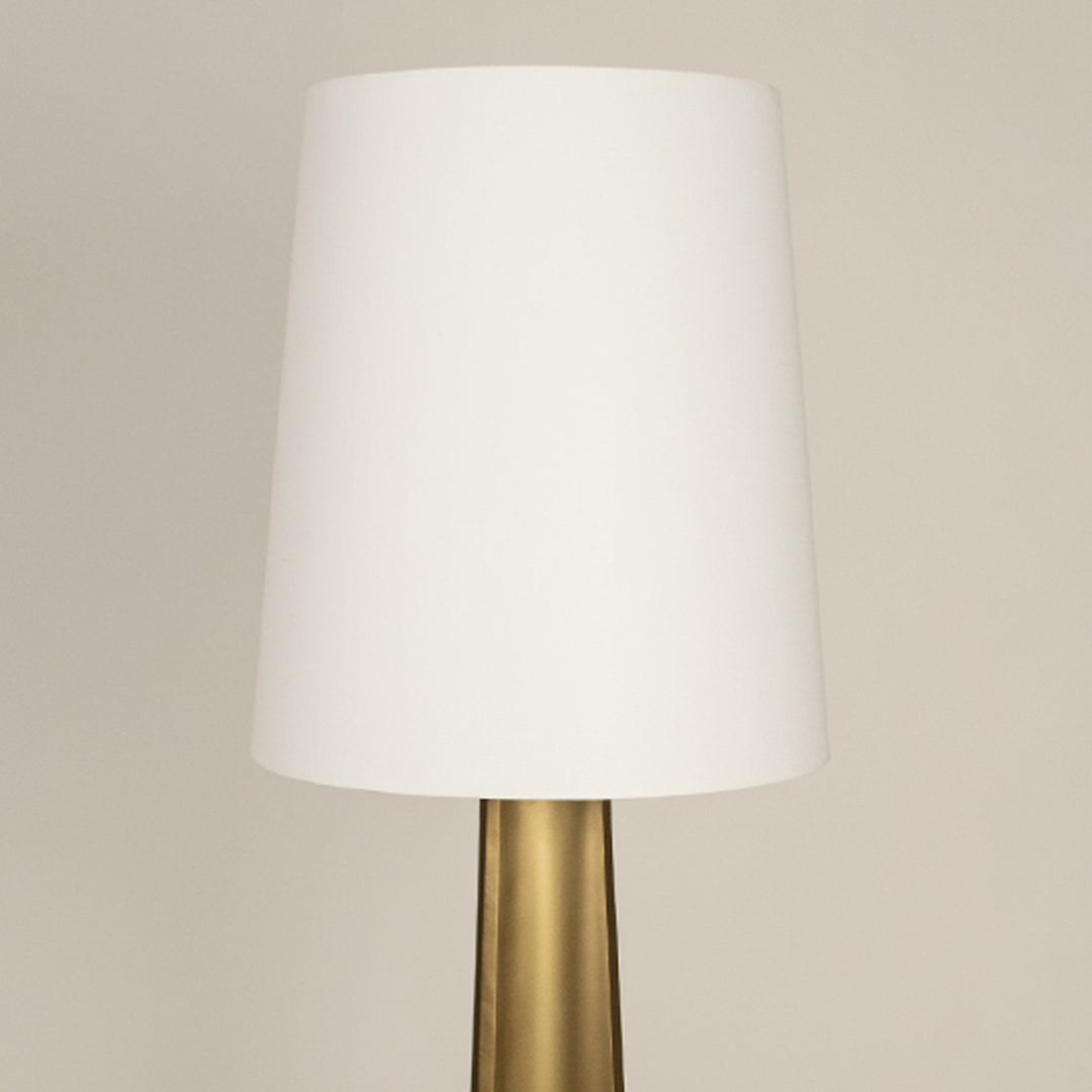 White fabric drum shade with brass metal stem showcasing refined craftsmanship and timeless contemporary design appeal.
