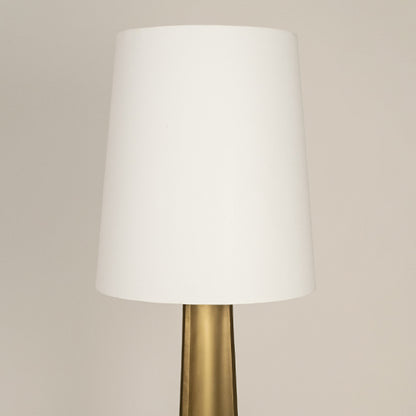 White fabric drum shade with brass metal stem showcasing refined craftsmanship and timeless contemporary design appeal.