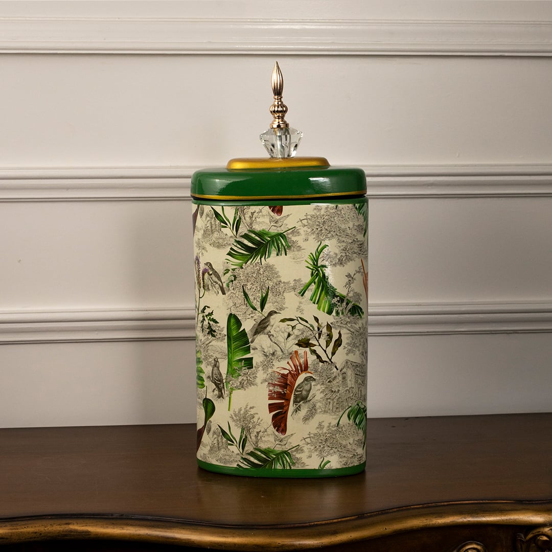 Tropical decorative jar on white background showcasing hand-painted tropical foliage design.