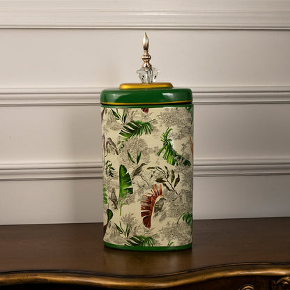 Tropical decorative jar on white background showcasing hand-painted tropical foliage design.