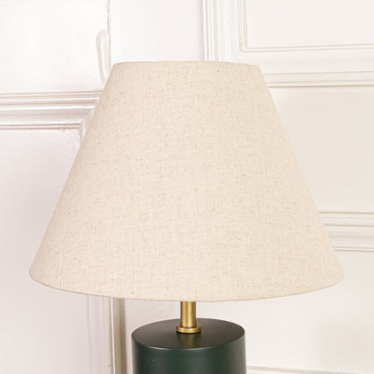 Closeup of table lamp fabric shade highlighting soft woven texture tapered shape and warm neutral tone for classic decor.