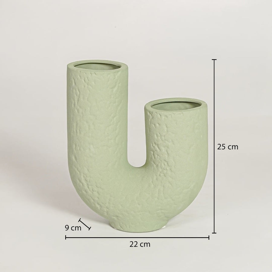 Light green ceramic U shaped vase measuring 25 cm height 22 cm width and 9 cm depth perfect for contemporary home decor styling.