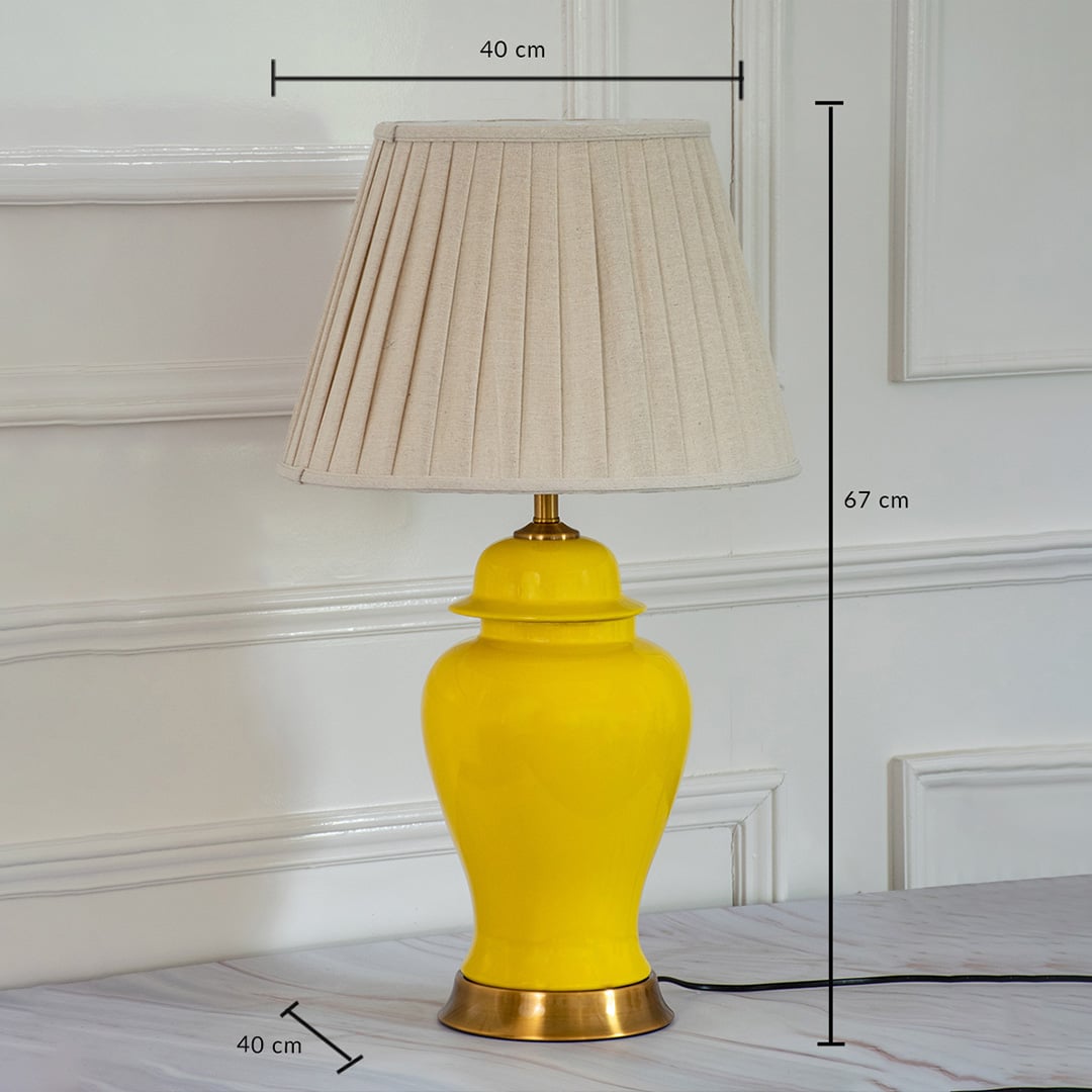 Yellow ceramic lamp with golden base pleated shade and size dimensions 67 cm height and 40 cm width.