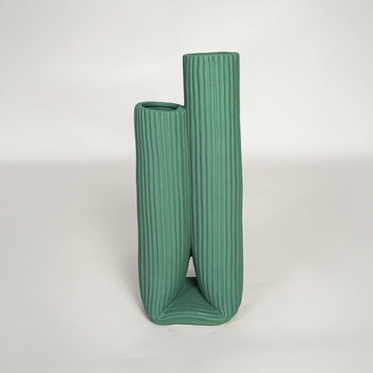 Modern green ceramic dual opening vase with ribbed surface ideal for shelf styling and contemporary decor display.