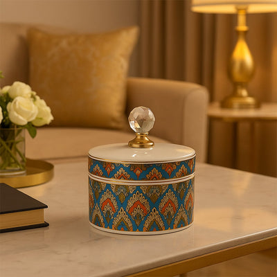 Colorful ceramic jar with crystal knob lid styled on table adding artistic elegance to living room home decor.