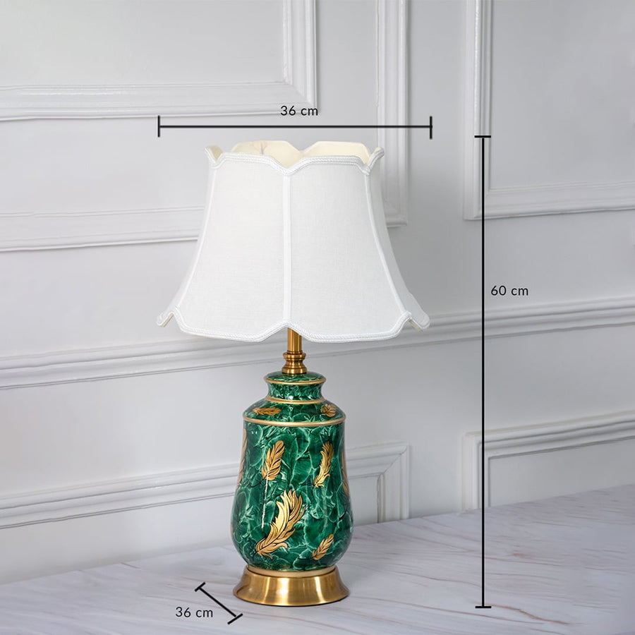 Designer ceramic table lamp measuring 60 cm in height and 36 cm in width crafted with a gold metal base and a white shade.