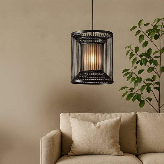 Cylindrical black wire pendant light adding a chic industrial touch and warm glow to elevate modern interior decor.