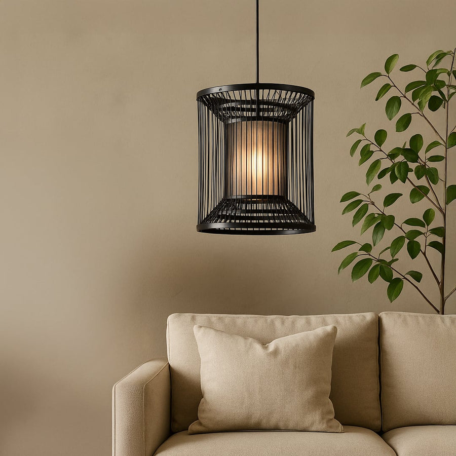 Cylindrical black wire pendant light adding a chic industrial touch and warm glow to elevate modern interior decor.