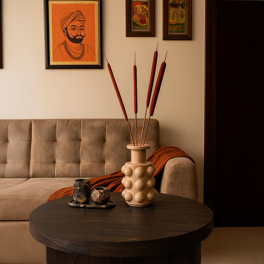 Cozy living room setup with sofa coffee table wall art and decorative accents creating warm inviting home interior ambiance.