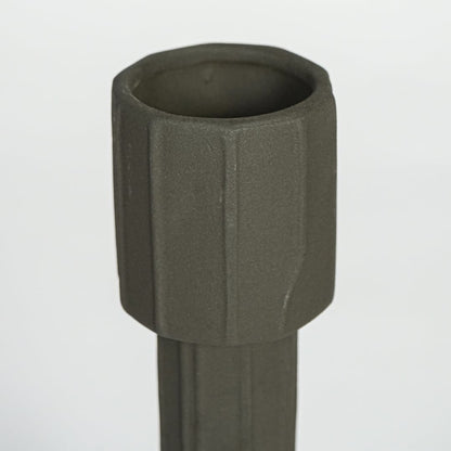 Dark green metal decorative candle holder with faceted cylindrical design isolated on clean white background for modern decor styling.