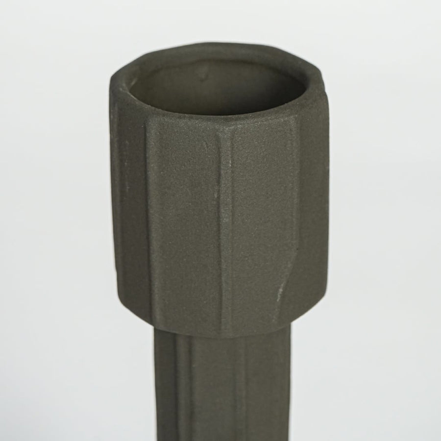 Dark green metal decorative candle holder with faceted cylindrical design isolated on clean white background for modern decor styling.