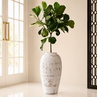 Tall textured white artisan floor vase with green plant for elegant minimalist home decor and sophisticated interior.