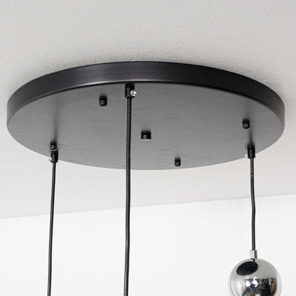 Black metal round ceiling canopy with suspended cords showcasing sleek modern craftsmanship and finish.