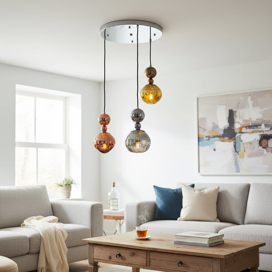 Gold chrome and copper cluster pendant lights hanging in a modern room adding a stylish contemporary decorative look to home interiors.