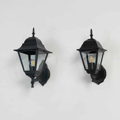 Group of outdoor wall lanterns in black finish displayed off on white background showing detailed glass and metal design.