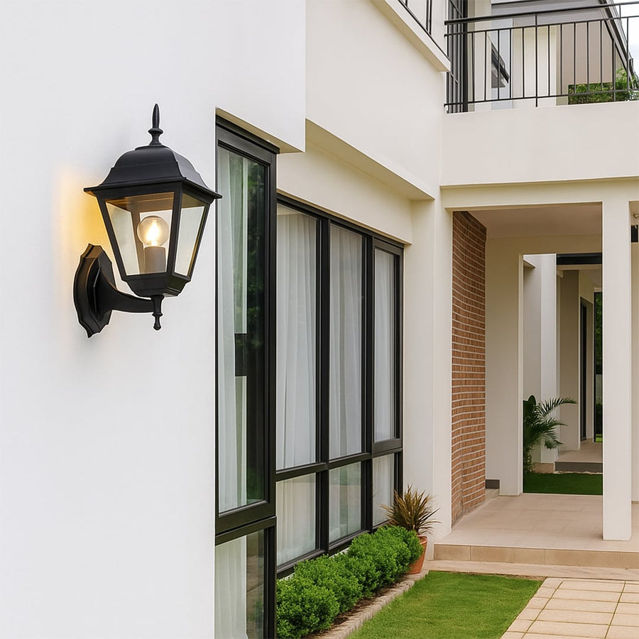 Stylish outdoor wall lantern in matte black finish bringing timeless charm and soft warm glow to exterior home walls.