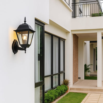 Stylish outdoor wall lantern in matte black finish bringing timeless charm and soft warm glow to exterior home walls.