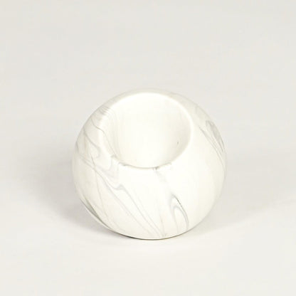 Modern white marble look ceramic vase with spherical body isolated on white background for tabletop styling.