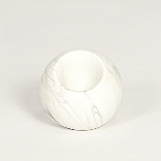 Modern white marble look ceramic vase with spherical body isolated on white background for tabletop styling.