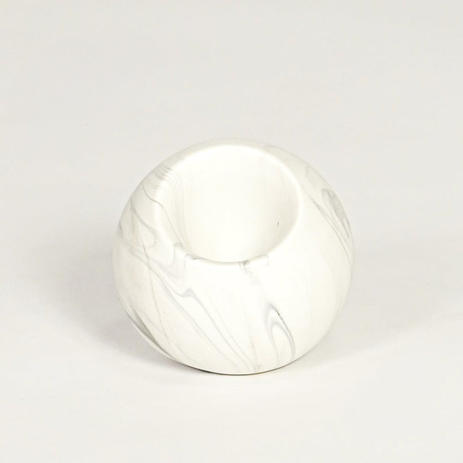 Modern white marble look ceramic vase with spherical body isolated on white background for tabletop styling.