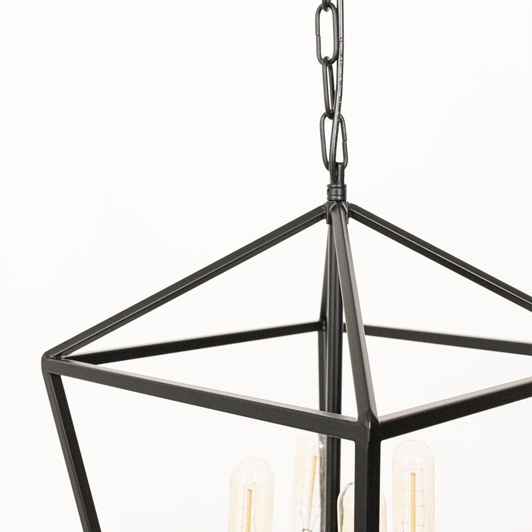 Closeup view of black metal pendant light with clear glass bulbs showcasing its geometric frame and modern minimalist lighting design.
