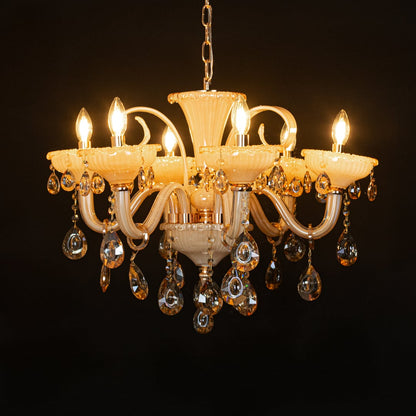 Golden glass crystal chandelier glowing warmly on black background creating a rich luxury ceiling feature.