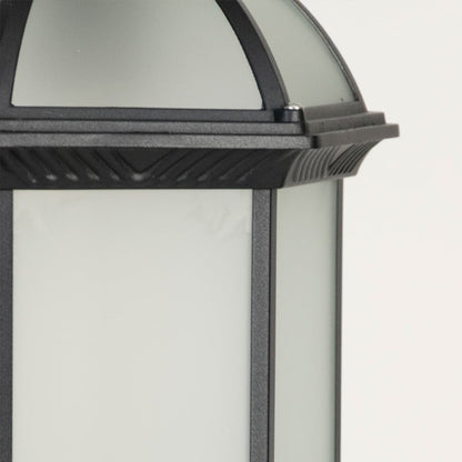 Outdoor wall lantern in black metal with glass panels highlighting classic design and warm illumination for exterior home decor.