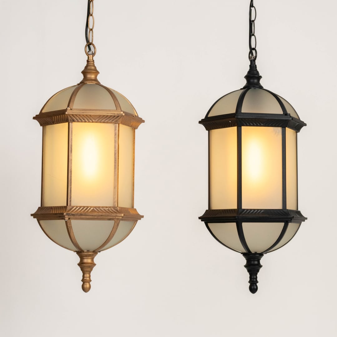 A grouped display of two outdoor hanging lanterns turned on showing both gold and black finishes with warm illumination enhancing their elegant classic exterior design.