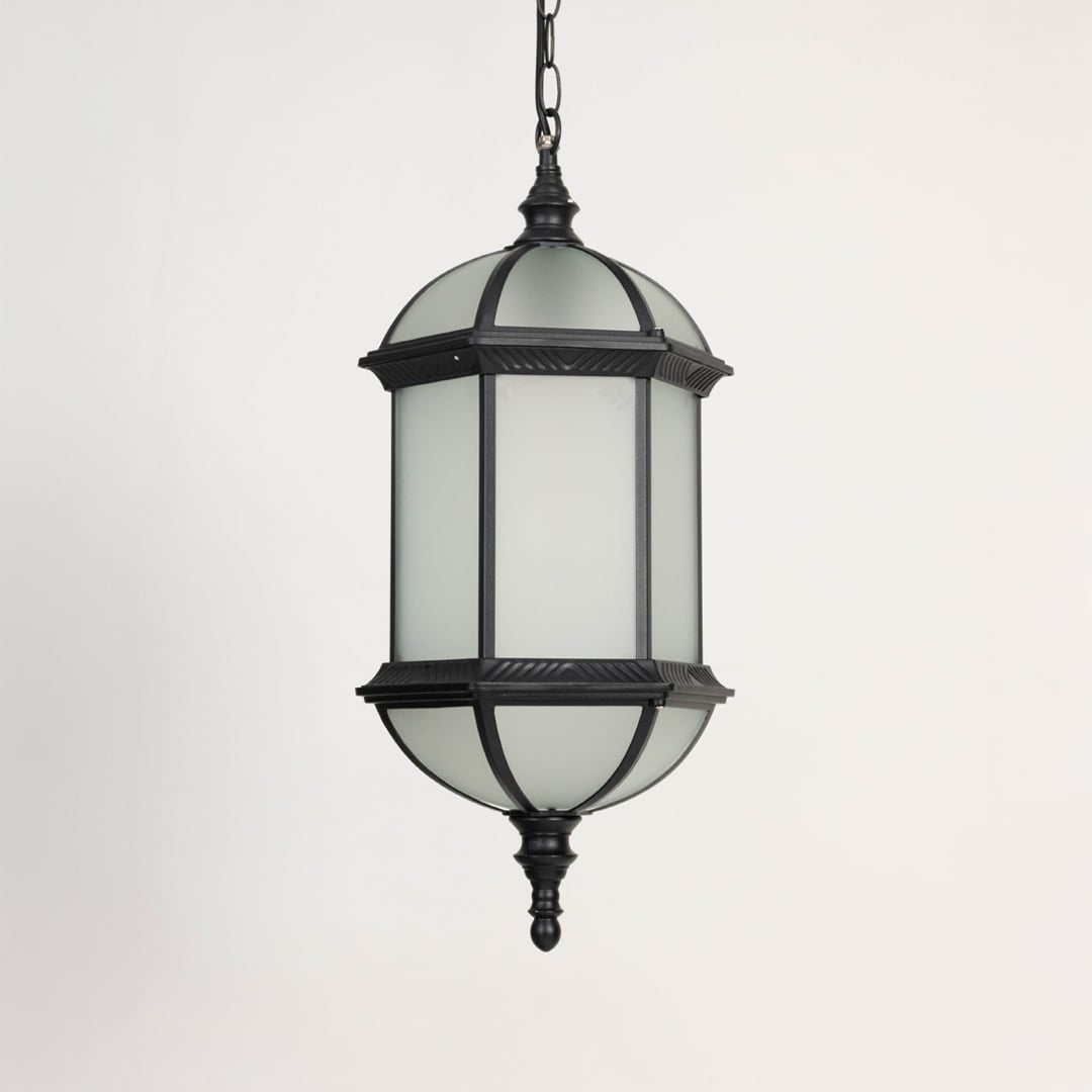 A decorative outdoor hanging lantern light turned off shown on a white background featuring its metal frame frosted glass body and elegant dome shaped top in clear detail.