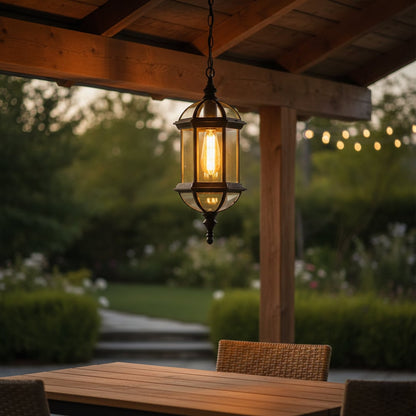 Antique brass hanging lantern light illuminating stylish outdoor dining patio with cozy ambient glow.