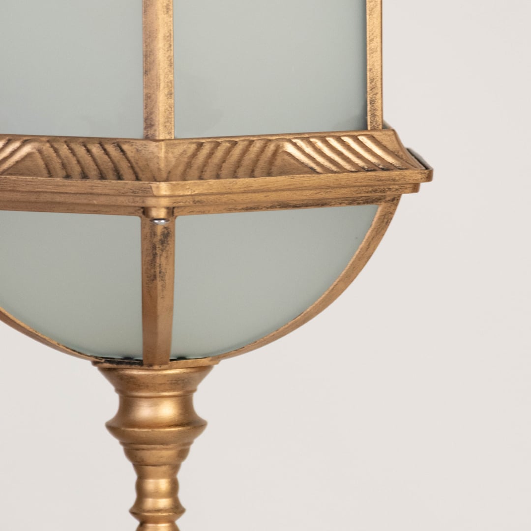 A closeup view of the hanging lantern showing the frosted glass panels detailed metal edging and smooth dome top capturing the vintage elegance of the design.