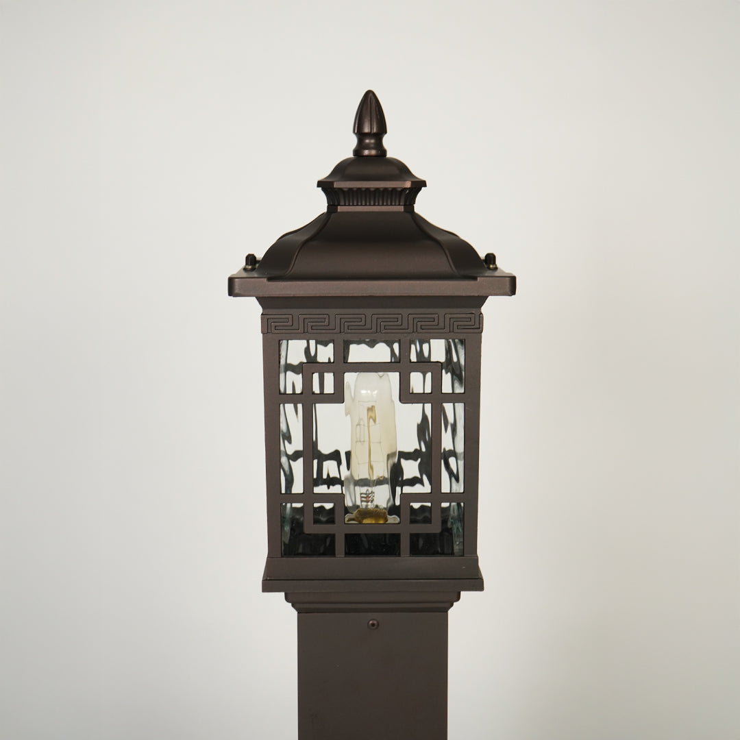 Close view of outdoor lantern pole light with glass enclosure showcasing durable weather resistant classic lighting design.
