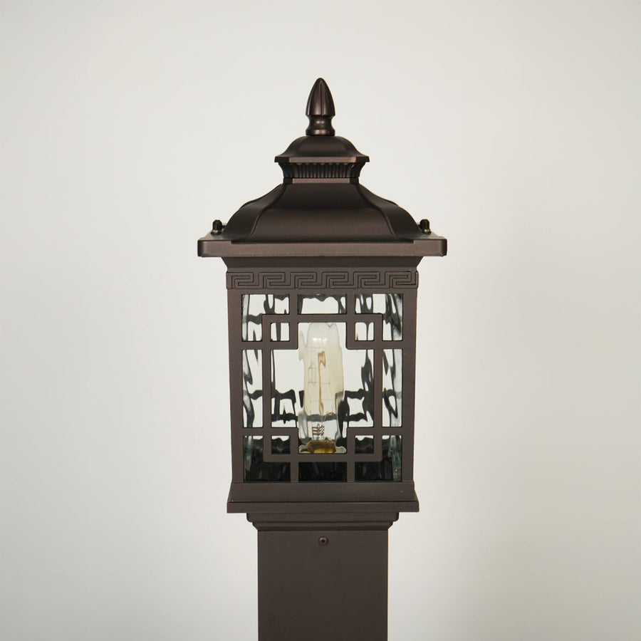 Close view of outdoor lantern pole light with glass enclosure showcasing durable weather resistant classic lighting design.
