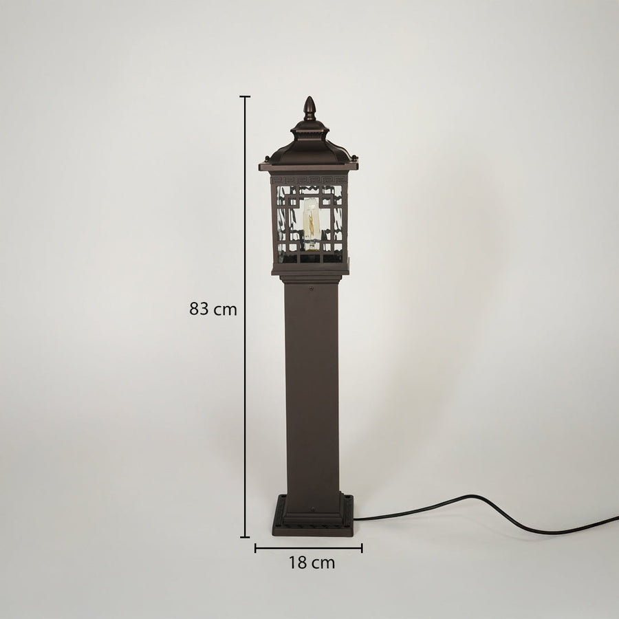 Traditional outdoor pillar lamp with dark metal finish and decorative glass housing on neutral background 83 cm height 18 cm width ideal for exterior garden lighting.

