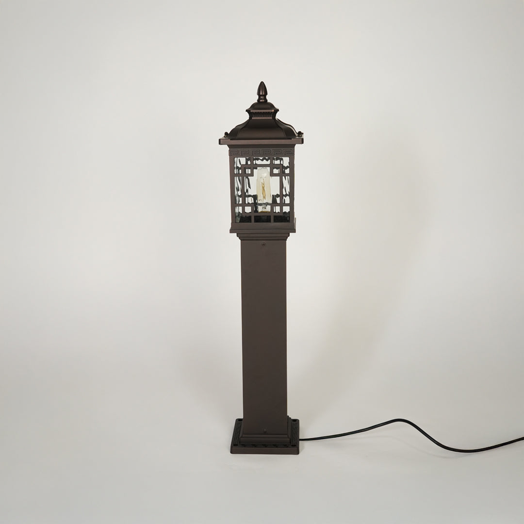 Traditional outdoor pathway light with decorative lantern top and black metal body on clean background ideal for exterior lighting setup.