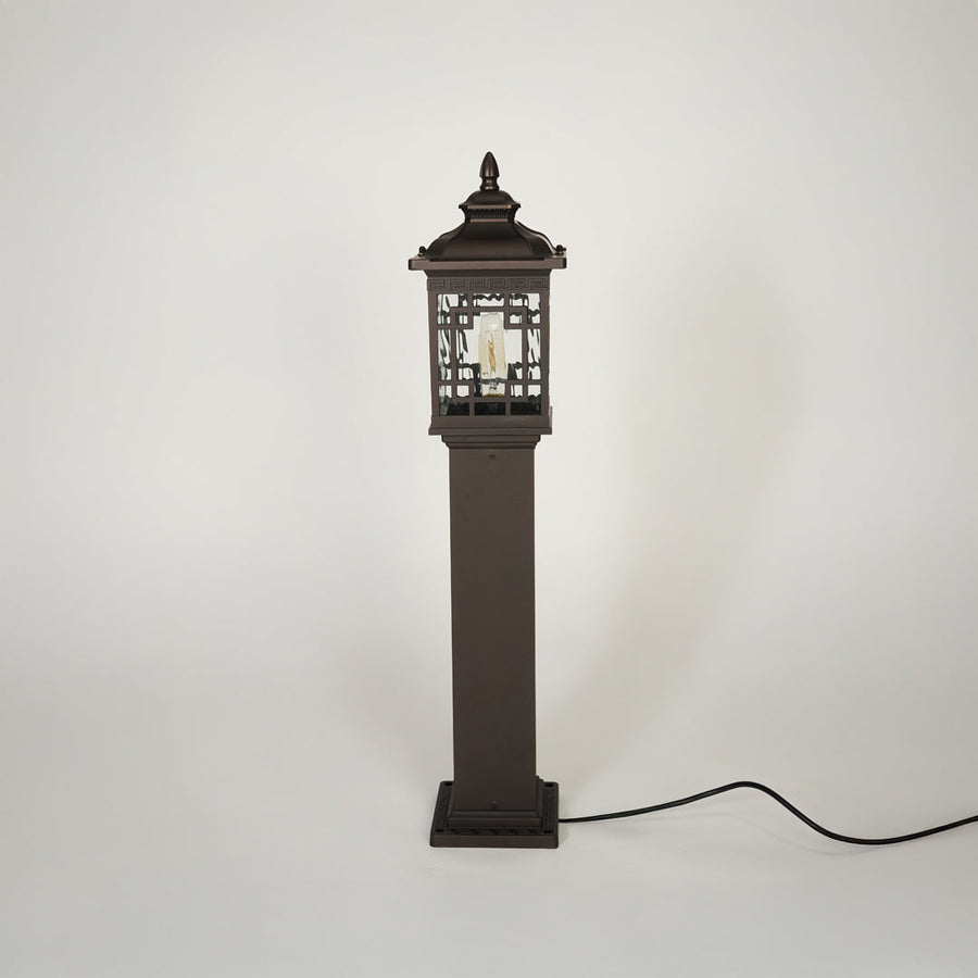 Traditional outdoor pathway light with decorative lantern top and black metal body on clean background ideal for exterior lighting setup.
