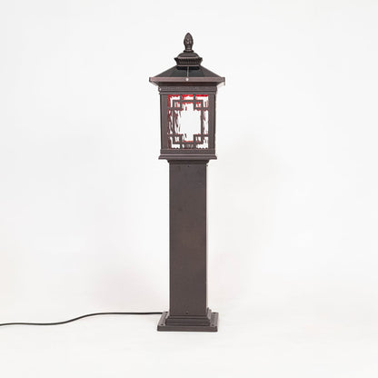 Classic black pillar lamp post glowing softly with frosted glass shade ideal for outdoor entrance lighting decor.
