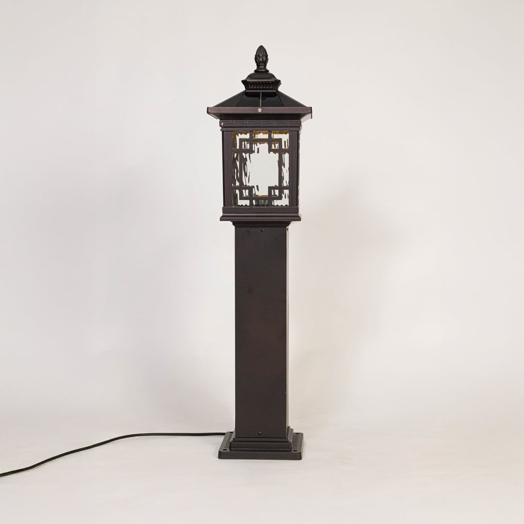 Outdoor post lantern in black metal with glass panels displayed on white background highlighting classic garden lighting style.