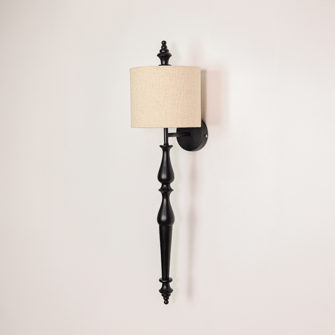 Lamp styled wall light off on white background featuring slim black metal arm with classic fabric shade for minimalist product display.