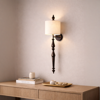 Lamp styled wall light glowing on soft beige wall above wooden console with black metal stem and fabric shade creating warm luxury Decor.
