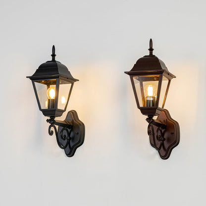 Classic black and bronze metal glass outdoor wall lantern set shown lit together on white background for exterior home lighting Light on white BG.