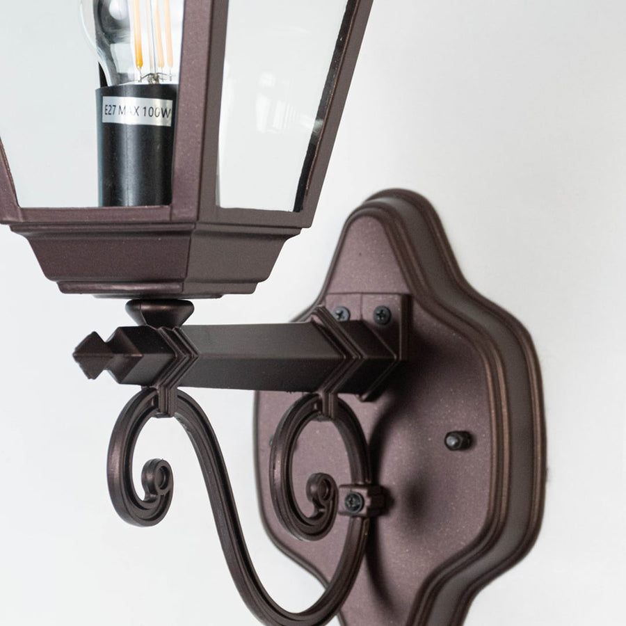 Closeup of brown metal Valera outdoor wall light displaying textured surface sturdy construction and classic exterior wall lighting style.
